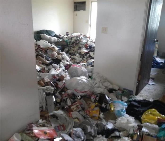 Piles of garbage in hoarder apartment