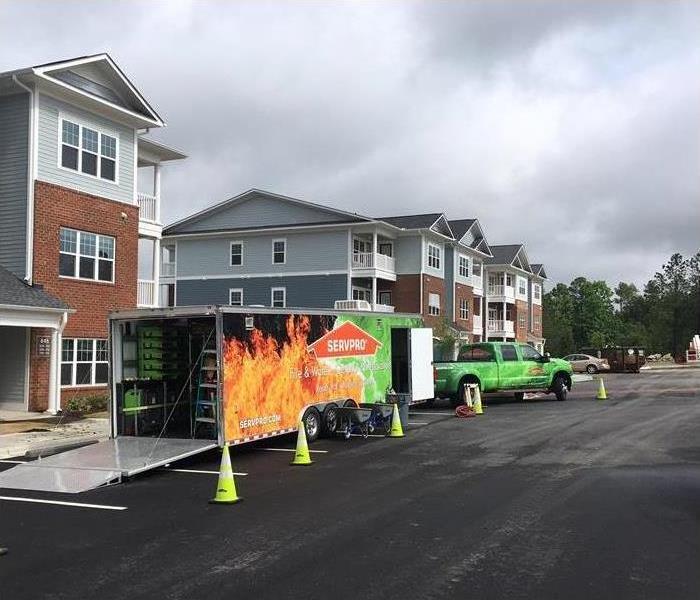 SERVPRO vehicles parked in front of businesses